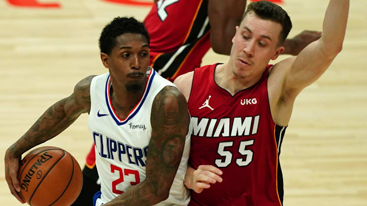 Feb 15, 2021; Los Angeles, California, USA; LA Clippers guard Lou Williams (23) passes the ball around the back of Miami Heat guard Duncan Robinson (55) in the second half at Staples Center. Mandatory Credit: Kirby Lee-Imagn Images Feb 15, 2021; Los Angeles, California, USA; LA Clippers guard Lou Williams (23) passes the ball around the back of Miami Heat guard Duncan Robinson (55) in the second half at Staples Center. Mandatory Credit: Kirby Lee-Imagn Images
