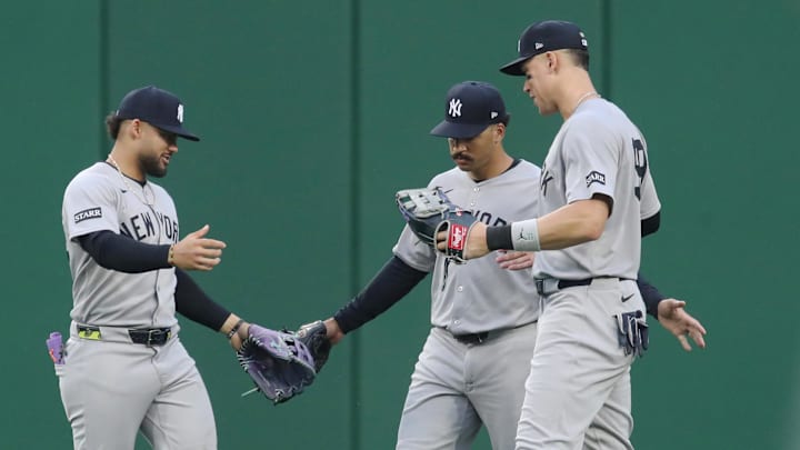 Apr 5, 2025; Pittsburgh, Pennsylvania, USA;  New York Yankees outfielder Jasson Dominguez (left), center fielder Trent Grisham (middle), and right fielder Aaron Judge (right) celebrate in the outfield after defeating the Pittsburgh Pirates at PNC Park. 