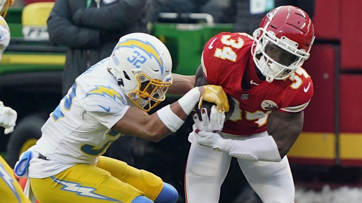 Jan 3, 2021; Kansas City, Missouri, USA; Kansas City Chiefs running back Darwin Thompson (34) runs against Los Angeles Chargers safety Alohi Gilman (32) during the first half at Arrowhead Stadium. Mandatory Credit: Jay Biggerstaff-Imagn Images