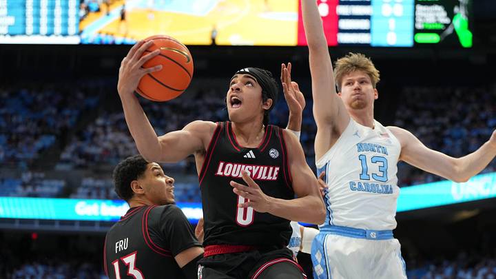 Feb 23, 2026; Chapel Hill, North Carolina, USA; Louisville Cardinals guard Mikel Brown Jr. (0) shoots as North Carolina Tar Heels center Henri Veesaar (13) defends in the first half at Dean E. Smith Center. Mandatory Credit: Bob Donnan-Imagn Images