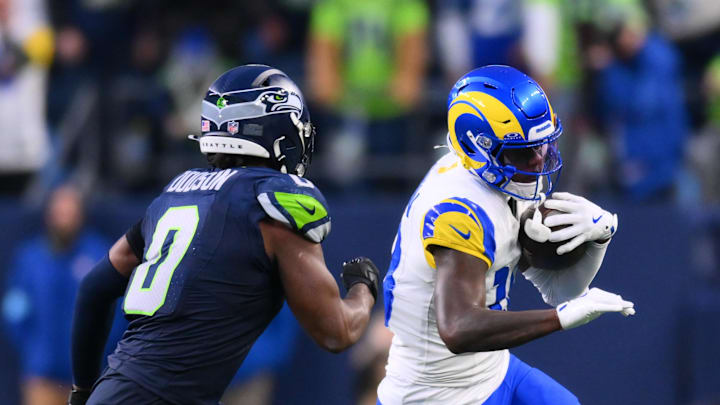 Nov 3, 2024; Seattle, Washington, USA; Los Angeles Rams wide receiver Tyler Johnson (18) carries the ball after a catch while defended by Seattle Seahawks linebacker Tyrel Dodson (0) during the second half at Lumen Field. Mandatory Credit: Steven Bisig-Imagn Images Nov 3, 2024; Seattle, Washington, USA; Los Angeles Rams wide receiver Tyler Johnson (18) carries the ball after a catch while defended by Seattle Seahawks linebacker Tyrel Dodson (0) during the second half at Lumen Field. Mandatory Credit: Steven Bisig-Imagn Images