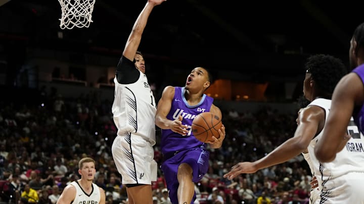 Jul 14, 2025; Las Vegas, NV, USA;  Utah Jazz forward John Tonje (17) drives towards the basket against San Antonio Spurs forward Carter Bryant (11) during the first half of a NBA basketball game at the Thomas & Mack Center. Mandatory Credit: Lucas Peltier-Imagn Images