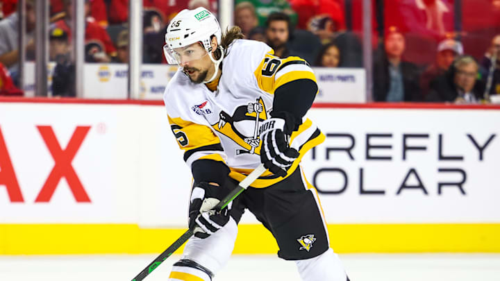 Oct 22, 2024; Calgary, Alberta, CAN; Pittsburgh Penguins defenseman Erik Karlsson (65) controls the puck against the Calgary Flames during the third period at Scotiabank Saddledome.