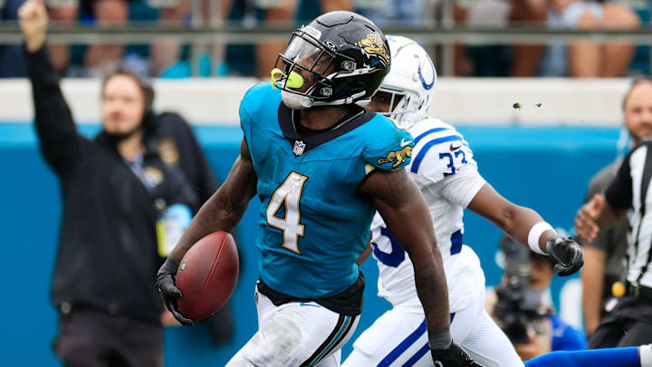 Jacksonville Jaguars running back Tank Bigsby (4) outpaces Indianapolis Colts cornerback Samuel Womack III (33) for a touchdown score during the fourth quarter of an NFL football matchup Sunday, Oct. 6, 2024 at EverBank Stadium in Jacksonville, Fla. The Jaguars edged the Colts on a field goal 37-34. [Corey Perrine/Florida Times-Union]