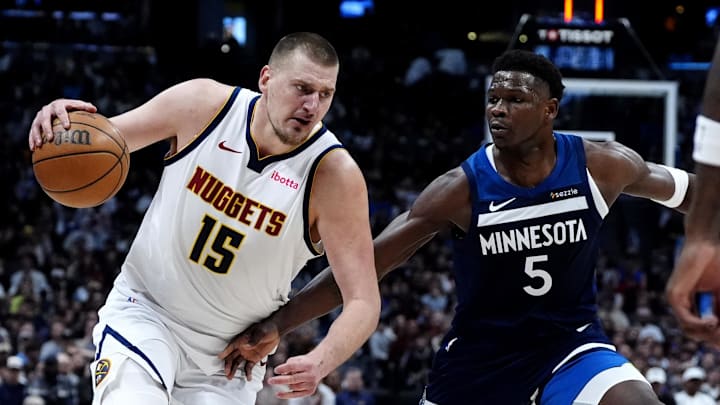 Mar 12, 2025; Denver, Colorado, USA; Minnesota Timberwolves guard Anthony Edwards (5) defends Denver Nuggets center Nikola Jokic (15) in the second half at Ball Arena.