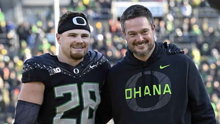 Nov 22, 2025; Eugene, Oregon, USA; Oregon Ducks linebacker Bryce Boettcher (28) poses for a photo head coach Dan Lanning before the game against the Southern California Trojans at Autzen Stadium. Mandatory Credit: Troy Wayrynen-Imagn Images