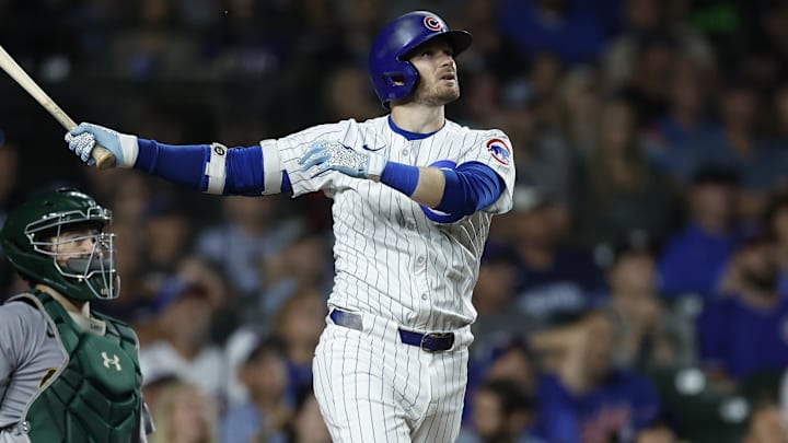 Sep 17, 2024; Chicago, Illinois, USA; Chicago Cubs outfielder Ian Happ (8) hits a solo home run against the Oakland Athletics during the third inning at Wrigley Field. Mandatory Credit: Kamil Krzaczynski-Imagn Images