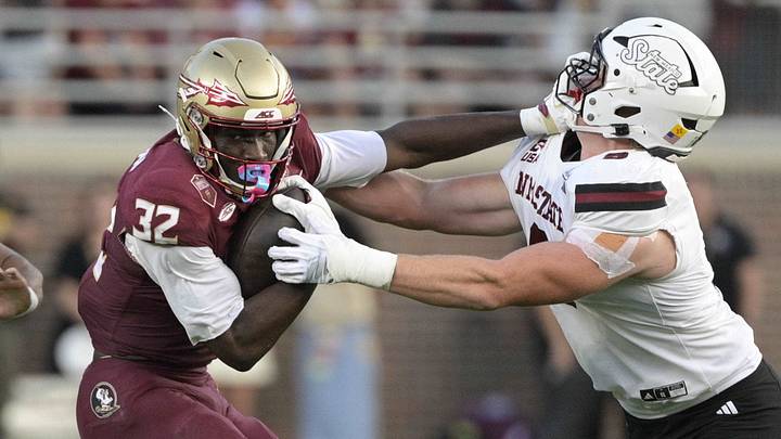 Aug 29, 2026; Tallahassee, Florida, USA; Florida State running back Ousmane Kromah (32) runs for a gain past New Mexico State safety Nick Session (5) during the first quarter at Doak S. Campbell Stadium. Mandatory Credit: Melina Myers-Imagn Images Aug 29, 2026; Tallahassee, Florida, USA; Florida State running back Ousmane Kromah (32) runs for a gain past New Mexico State safety Nick Session (5) during the first quarter at Doak S. Campbell Stadium. Mandatory Credit: Melina Myers-Imagn Images