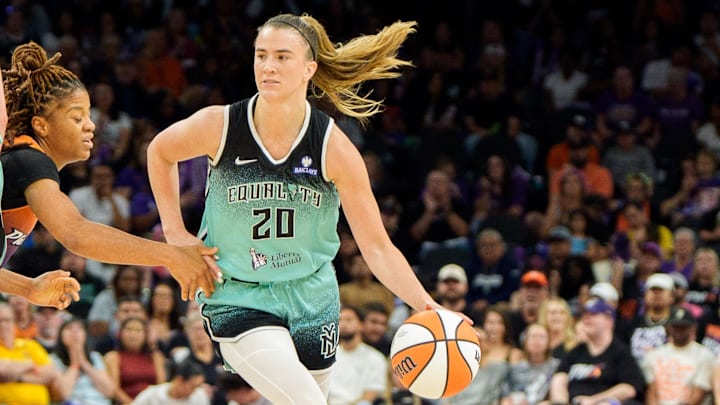 Sep 14, 2025; Phoenix, Arizona, USA; New York Liberty forward Breanna Stewart (30) sets a pick for guard Sabrina Ionescu (20) as she drives past Phoenix Mercury guard Monique Akoa Makani (8) in the second half during game one of the 2025 WNBA Playoffs round one at PHX Arena. Mandatory Credit: Allan Henry-Imagn Images
