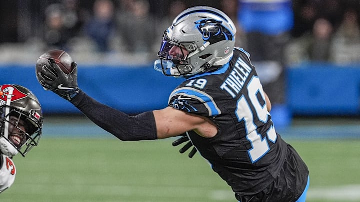 Dec 1, 2024; Charlotte, North Carolina, USA; Carolina Panthers wide receiver Adam Thielen (19) makes a one handed catch defended by Tampa Bay Buccaneers safety Antoine Winfield Jr. (31) during the second half at Bank of America Stadium. Mandatory Credit: Jim Dedmon-Imagn Images