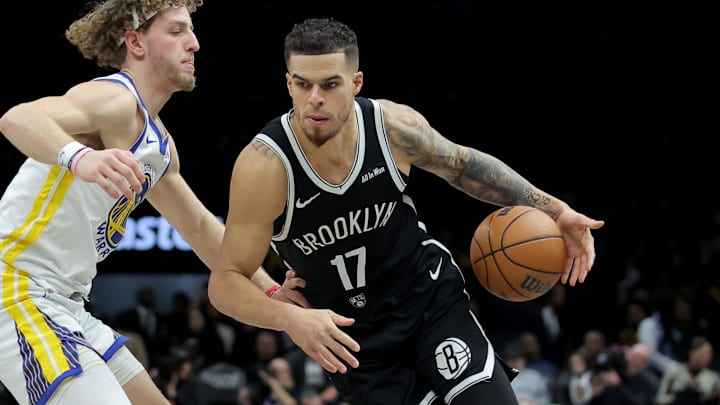Dec 29, 2025; Brooklyn, New York, USA; Brooklyn Nets forward Michael Porter Jr. (17) drives to the basket against Golden State Warriors guard Brandin Podziemski (2) during the third quarter at Barclays Center. Mandatory Credit: Brad Penner-Imagn Images