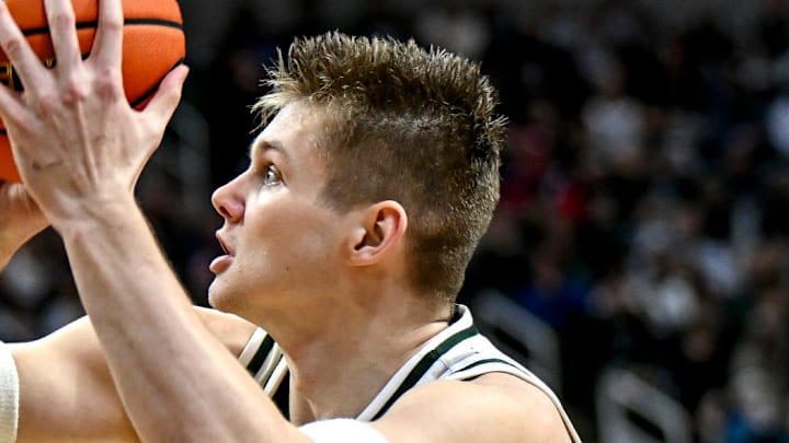 Michigan State's Jaxon Kohler, right, scores as Maryland's Solomon Washington defends during the first half on Saturday, Jan. 24, 2026, at the Breslin Center in East Lansing.