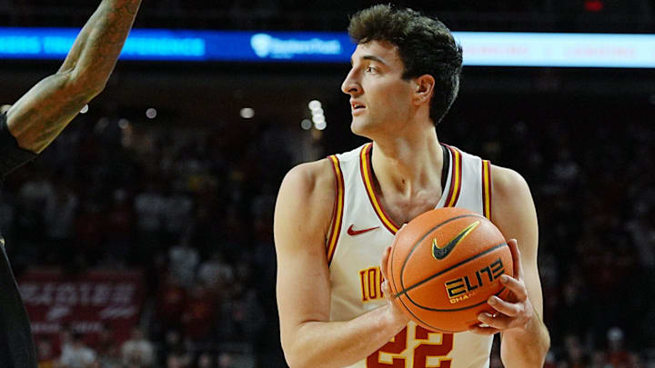 Iowa State Cyclones forward Milan Momcilovic (22) looks for pass around UCF Knights guard Kris Parker (5) during the first half in the Big-12 conference men’s basketball on Jan. 20, 2026, at Hilton Coliseum in Ames, Iowa.