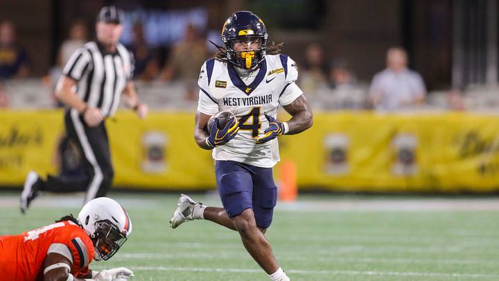 Sep 19, 2026; Charlotte, North Carolina, USA;  West Virginia Mountaineers running back Cam Cook (4) runs the ball during the first quarter against the Virginia Cavaliers at Bank of America Stadium.  Mandatory Credit: Ben Queen-Imagn Images