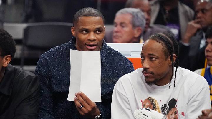 Apr 7, 2026; San Francisco, California, USA;  Sacramento Kings forward-guard De'Andre Hunter (15), guard Russell Westbrook (18), and guard-forward DeMar DeRozan (10), wearing an Azzi Fudd t-shirt, watch the action against the Golden State Warriors in the second quarter at Chase Center.