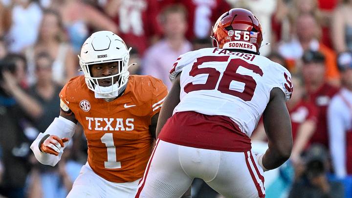 Oklahoma Sooners offensive lineman Michael Fasusi (56) blocks Texas Longhorns defensive end Colin Simmons (1) during the game between the Texas Longhorns and the Oklahoma Sooners at the Cotton Bowl. Oklahoma Sooners offensive lineman Michael Fasusi (56) blocks Texas Longhorns defensive end Colin Simmons (1) during the game between the Texas Longhorns and the Oklahoma Sooners at the Cotton Bowl.