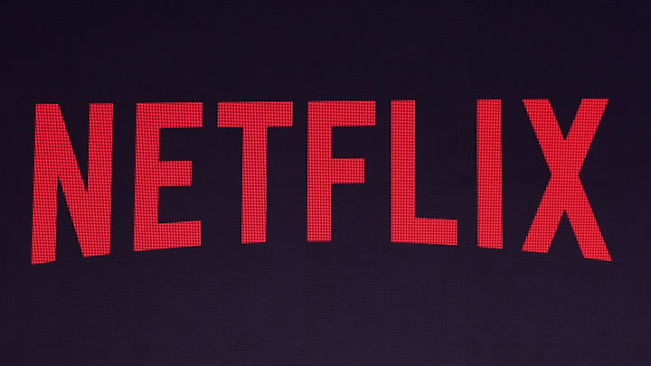 Indian comedian and poet Zakir Khan, stands near the Netflix logo