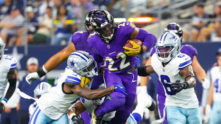 Sep 22, 2024; Arlington, Texas, USA; Baltimore Ravens running back Derrick Henry (22) runs during the first half as Dallas Cowboys safety Donovan Wilson (6) and Dallas Cowboys cornerback Jourdan Lewis (2) defend at AT&T Stadium. 