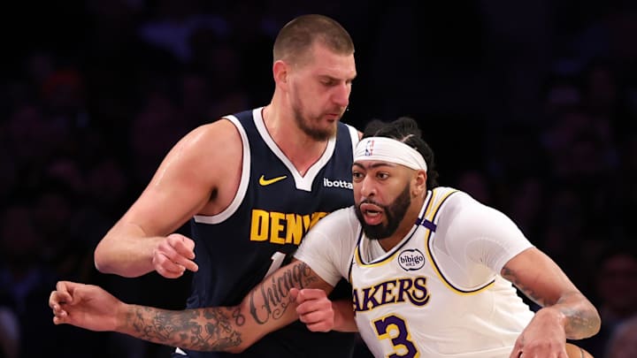 Nov 23, 2024; Los Angeles, California, USA;  Los Angeles Lakers forward Anthony Davis (3) posts up against Denver Nuggets center Nikola Jokic (15) during the first half at Crypto.com Arena.