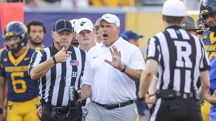 Sep 13, 2025; Morgantown, West Virginia, USA; West Virginia Mountaineers head coach Rich Rodriguez yells at the referee during the second quarter against the Pittsburgh Panthers at Milan Puskar Stadium. Mandatory Credit: Ben Queen-Imagn Images