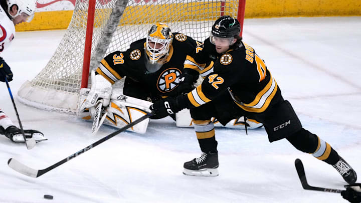 Providence Bruins goalie Michael DiPietro and defender Frederic Brunet deflect the puck from Thunderbird Dylan Peterson away from the Providence goal.