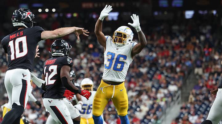 Aug 13, 2026; Houston, Texas, USA;  Texans quarterback Davis Mills (10) attempts a pass as Chargers cornerback Avery Smith (36) leaps to defend during the third quarter at Reliant Stadium. Mandatory Credit: Troy Taormina-Imagn Images