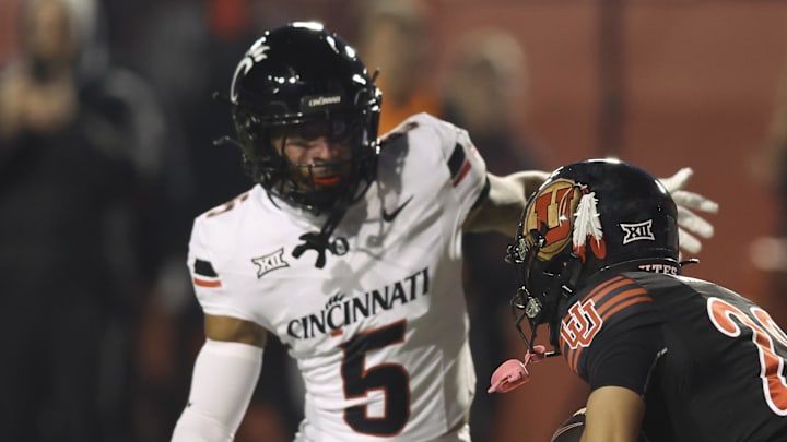 Cincinnati Bearcats safety Christian Harrison (5) tackles Utah Utes wide receiver Mana Carvalho (28) on a punt return during the first quarter at Rice-Eccles Stadium.