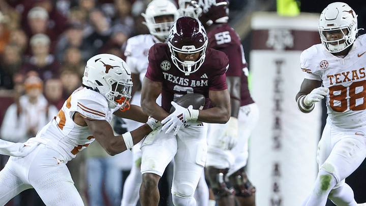 Texas A&M Aggies wide receiver Terry Bussey (2) runs with the ball as Texas Longhorns linebacker Ty'Anthony Smith (26) attempts to make a tackle during the fourth quarter at Kyle Field. Texas A&M Aggies wide receiver Terry Bussey (2) runs with the ball as Texas Longhorns linebacker Ty'Anthony Smith (26) attempts to make a tackle during the fourth quarter at Kyle Field.