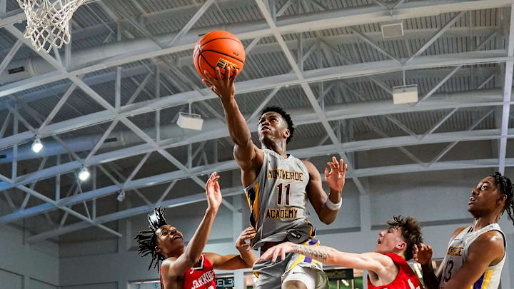 Montverde Academy Eagles guard CJ Ingram (11) goes for a lay up as Archbishop Carroll Patriots defenders try to block it during the fourth quarter of the first round of the 51st annual City of Palms Classic at Suncoast Credit Union Arena in Fort Myers on Wednesday, Dec. 18, 2024.