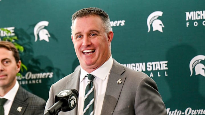 Michigan State's new football coach Pat Fitzgerald, right,, talks during his introductory press conference on Tuesday, Dec. 2, 2025, at the Tom Izzo Football Building in East Lansing. At left, MSU Athletic Director J Batt and MSU President Kevin Guskiewicz, center, look on. Michigan State's new football coach Pat Fitzgerald, right,, talks during his introductory press conference on Tuesday, Dec. 2, 2025, at the Tom Izzo Football Building in East Lansing. At left, MSU Athletic Director J Batt and MSU President Kevin Guskiewicz, center, look on.