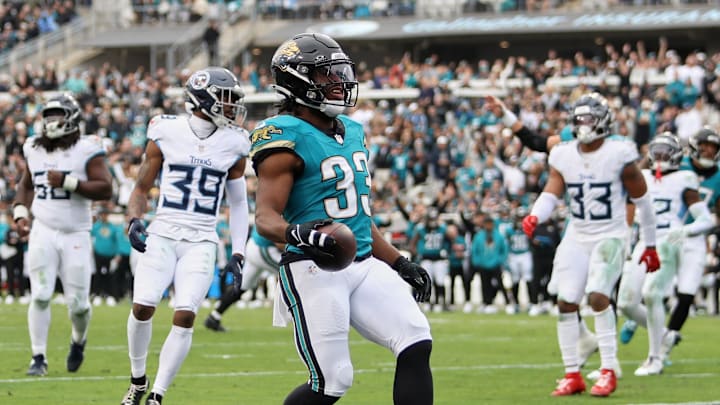 Jan 4, 2026; Jacksonville, Florida, USA; Jacksonville Jaguars running back Bhayshul Tuten (33) runs for a five-yard touchdown against the Tennessee Titans during the fourth quarter at EverBank Stadium. Mandatory Credit: Morgan Tencza-Imagn Images