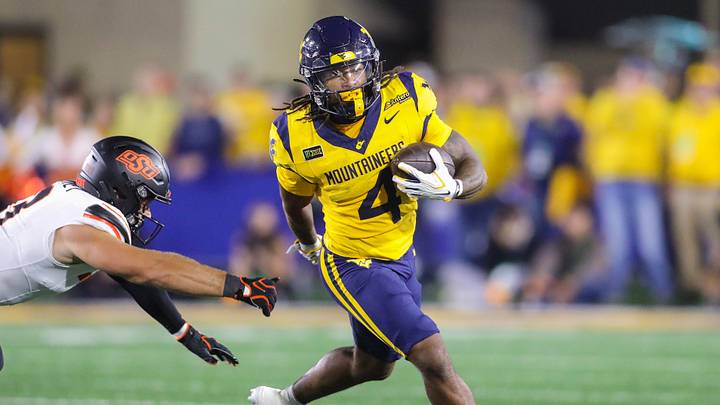 Sep 26, 2026; Morgantown, West Virginia, USA;  West Virginia Mountaineers running back Cam Cook (4) runs the ball during the first quarter against the Oklahoma State Cowboys at Milan Puskar Stadium.  Mandatory Credit: Ben Queen-Imagn Images
