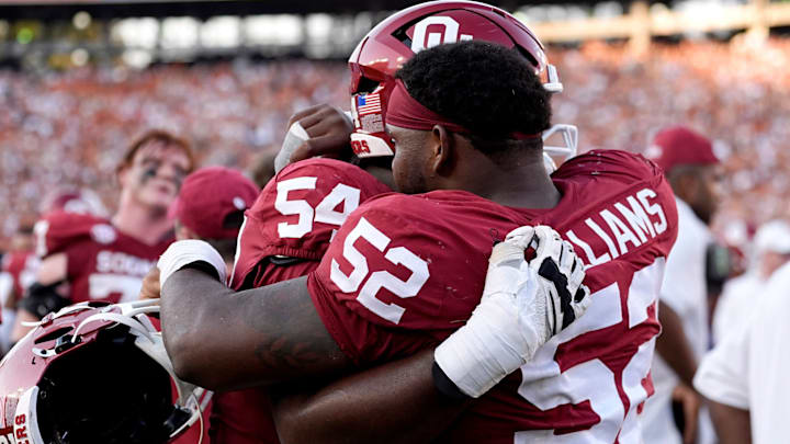 Oklahoma defensive lineman Damonic Williams (52) hugs offensive lineman Febechi Nwaiwu after the blowout in Dallas. Oklahoma defensive lineman Damonic Williams (52) hugs offensive lineman Febechi Nwaiwu after the blowout in Dallas.