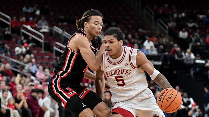 Dec 20, 2025; Newark, New Jersey, USA; Arkansas Razorbacks guard Darius Acuff Jr. (5) tries to drive past Houston Cougars guard Kingston Flemings (4) during the first half at Prudential Center. Dec 20, 2025; Newark, New Jersey, USA; Arkansas Razorbacks guard Darius Acuff Jr. (5) tries to drive past Houston Cougars guard Kingston Flemings (4) during the first half at Prudential Center.