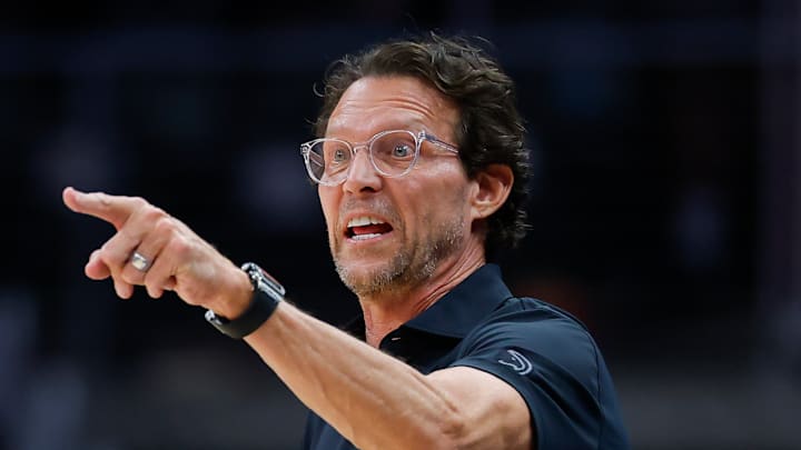 Quin Snyder points during a game against the Charlotte Hornets