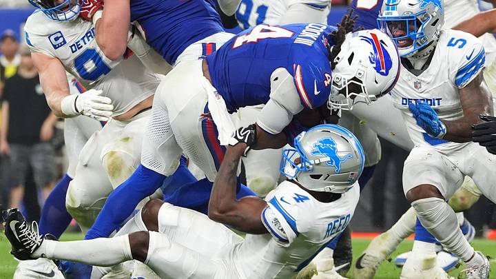 Detroit Lions cornerback D.J. Reed (4) tackles Buffalo Bills running back James Cook III (4) Detroit Lions cornerback D.J. Reed (4) tackles Buffalo Bills running back James Cook III (4)