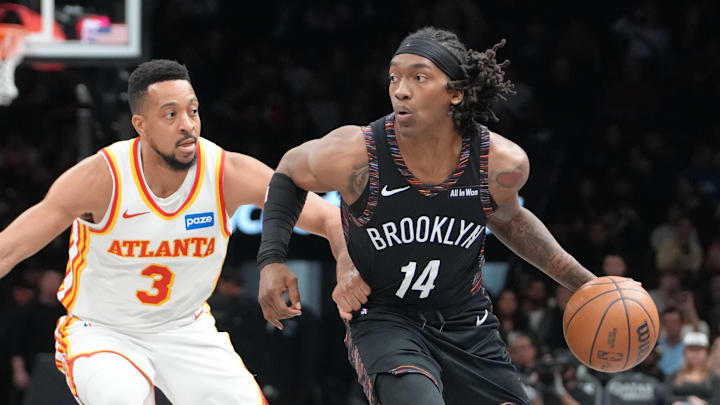 Apr 3, 2026; Brooklyn, New York, USA; Brooklyn Nets guard Terance Mann (14) dribbles the ball against Atlanta Hawks guard CJ McCollum (3) during the first half at Barclays Center. Mandatory Credit: Gregory Fisher-Imagn Images