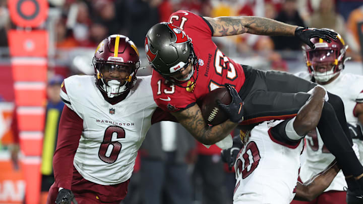 Jan 12, 2025; Tampa, Florida, USA; Tampa Bay Buccaneers wide receiver Mike Evans (13) is tackled by Washington Commanders safety Quan Martin (20) and linebacker Dante Fowler Jr. (6) during the third quarter of a NFC wild card playoff at Raymond James Stadium. Mandatory Credit: Kim Klement Neitzel-Imagn Images Jan 12, 2025; Tampa, Florida, USA; Tampa Bay Buccaneers wide receiver Mike Evans (13) is tackled by Washington Commanders safety Quan Martin (20) and linebacker Dante Fowler Jr. (6) during the third quarter of a NFC wild card playoff at Raymond James Stadium. Mandatory Credit: Kim Klement Neitzel-Imagn Images