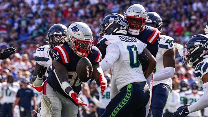 Sep 15, 2024; Foxborough, Massachusetts, USA; New England Patriots running back Rhamondre Stevenson (38) loses control of the ball against Seattle Seahawks linebacker Tyrel Dodson (0) in the second half at Gillette Stadium. Mandatory Credit: David Butler II-Imagn Images