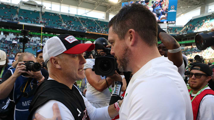 Texas Tech Red Raiders coach Joey McGuire and Oregon Ducks coach Dan Lanning meet at midfield following the 2025 Orange Bowl and quarterfinal game of the College Football Playoff at Hard Rock Stadium.