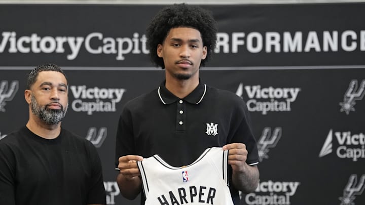 Jun 28, 2025; San Antonio, TX, USA; San Antonio first round draft pick Dylan Harper (2) holds up his jersey along with general manager Brian Wright at Victory Capital Performance Center. Mandatory Credit: Scott Wachter-Imagn Images Jun 28, 2025; San Antonio, TX, USA; San Antonio first round draft pick Dylan Harper (2) holds up his jersey along with general manager Brian Wright at Victory Capital Performance Center. Mandatory Credit: Scott Wachter-Imagn Images