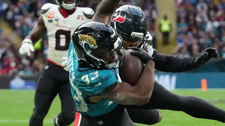 Oct 18, 2026; London, ENG;  Jacksonville Jaguars running back Bhayshul Tuten (33) is pushed out of bounds by Houston Texans cornerback Derek Stingley Jr. (24) during the second half at Wembley Stadium.