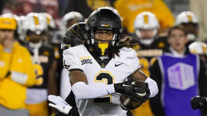 Sep 23, 2023; Laramie, Wyoming, USA; Appalachian State Mountaineers cornerback Tyrek Funderburk (2) makes an interception and runs for a touchdown against the Wyoming Cowboys during the fourth quarter at Jonah Field at War Memorial Stadium. Mandatory Credit: Troy Babbitt-USA TODAY Sports