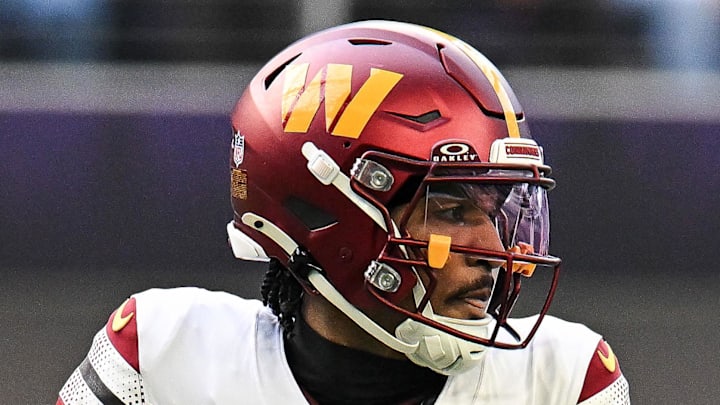Washington Commanders quarterback Jayden Daniels drops back to pass against the Minnesota Vikings.