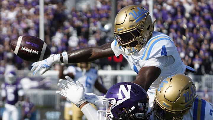 Sep 27, 2025; Evanston, Illinois, USA;UCLA Bruins defensive back Key Lawrence (4) and defensive back Robert Stafford III (3) defends Northwestern Wildcats wide receiver Hayden Eligon II (80) during the first half at Northwestern Medicine Field at Martin Stadium. Mandatory Credit: David Banks-Imagn Images