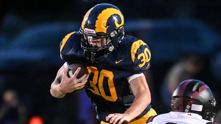 Marquette sophomore running back Bear Bonk (30) looks for running room versus Kenosha Bradford in a non-conference game on August 28, 2026. Marquette sophomore running back Bear Bonk (30) looks for running room versus Kenosha Bradford in a non-conference game on August 28, 2026.