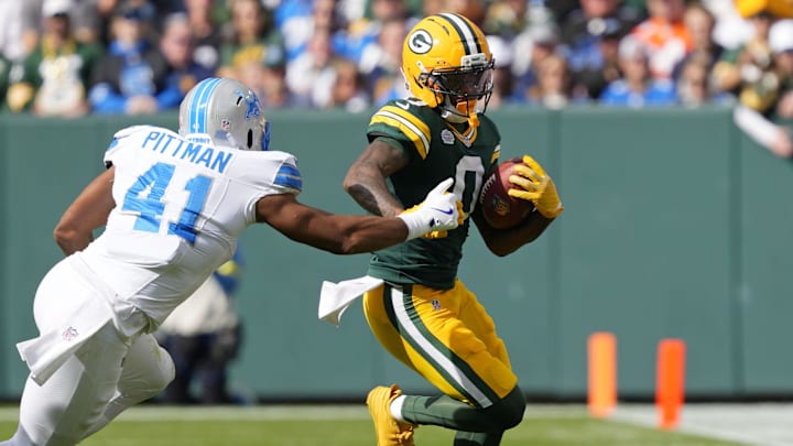 Sep 7, 2025; Green Bay, Wisconsin, USA; Green Bay Packers wide receiver Matthew Golden (0) runs with the ball against Detroit Lions linebacker Anthony Pittman (41) during the first quarter at Lambeau Field. Mandatory Credit: Jeff Hanisch-Imagn Images