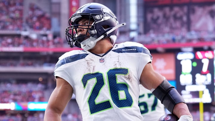 Dec 8, 2024; Glendale, Arizona, USA; Seattle Seahawks running back Zach Charbonnet (26) runs for a touchdown against the Arizona Cardinals during the first half at State Farm Stadium. Mandatory Credit: Joe Camporeale-Imagn Images