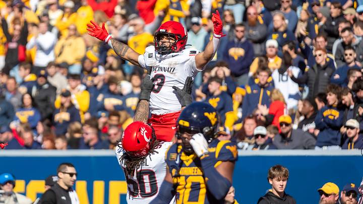 Oct 17, 2026; Morgantown, West Virginia, USA; Cincinnati Bearcats running back Cole Tabb (3) celebrates with offensive lineman Evan Tengesdahl (50) after a touchdown during the fourth quarter against the West Virginia Mountaineers at Milan Puskar Stadium. Mandatory Credit: Ben Queen-Imagn Images Oct 17, 2026; Morgantown, West Virginia, USA; Cincinnati Bearcats running back Cole Tabb (3) celebrates with offensive lineman Evan Tengesdahl (50) after a touchdown during the fourth quarter against the West Virginia Mountaineers at Milan Puskar Stadium. Mandatory Credit: Ben Queen-Imagn Images