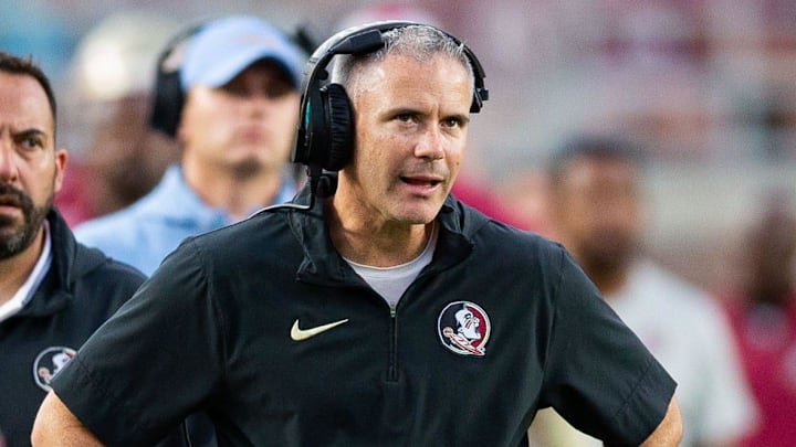 Florida State Seminoles head coach Mike Norvell talks on his headset as he coaches from the sideline. The Florida State Seminoles defeated the Virginia Tech Hokies 39-17 at Doak Campbell Stadium on Saturday, Oct. 7, 2023.